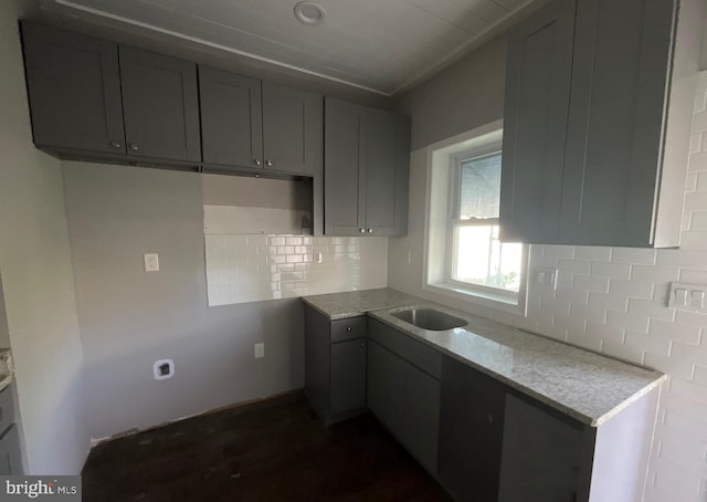 kitchen featuring decorative backsplash and dark wood-type flooring