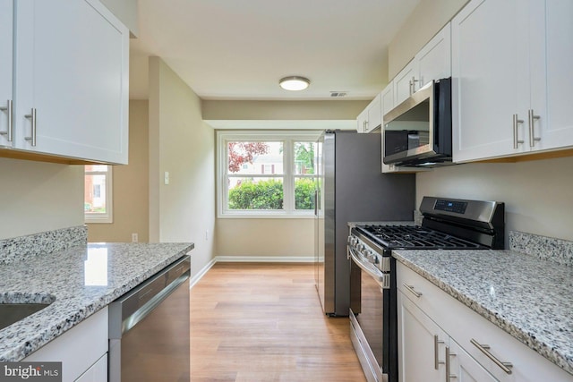 8321 Irongate Way, Manassas, VA 20109 - kitchen featuring appliances with stainless steel finishes, light wood-type flooring, white cabinetry, baseboards, and light stone countertops