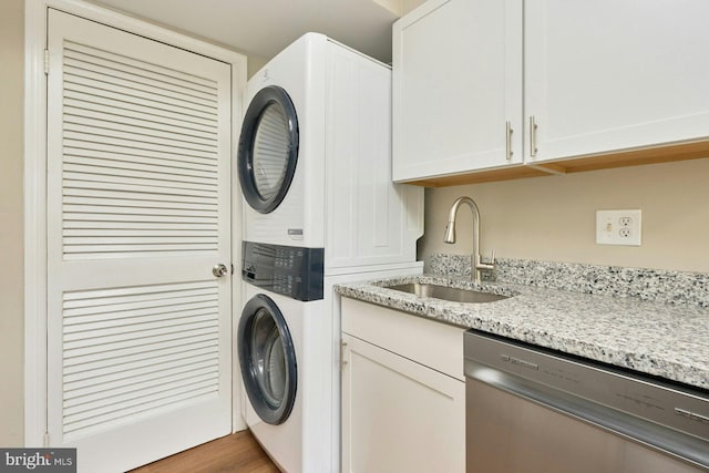 8321 Irongate Way, Manassas, VA 20109 - laundry area featuring stacked washer / drying machine, cabinet space, and wood finished floors