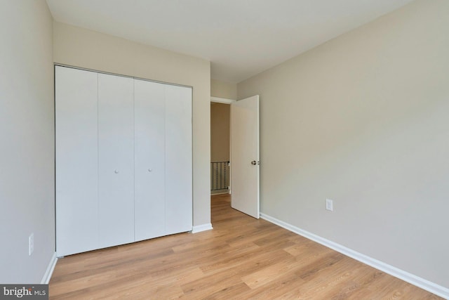 8321 Irongate Way, Manassas, VA 20109 - unfurnished bedroom featuring light wood-style flooring, baseboards, and a closet
