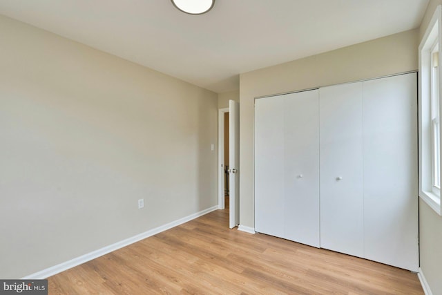 8321 Irongate Way, Manassas, VA 20109 - unfurnished bedroom featuring light wood-style floors, a closet, and baseboards