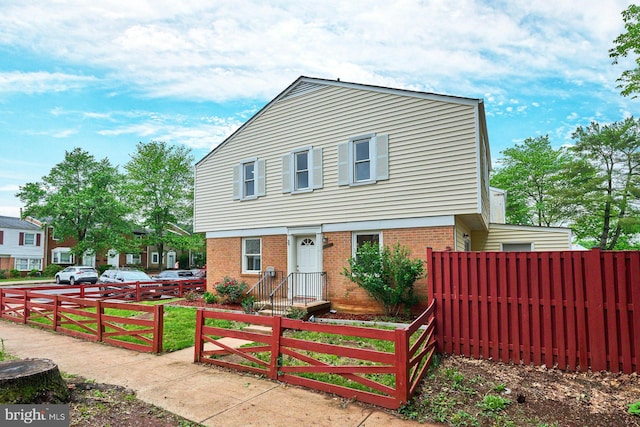 8321 Irongate Way, Manassas, VA 20109 - view of front facade featuring brick siding, a fenced front yard, and a gate