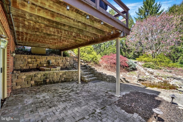 view of patio / terrace featuring stairs