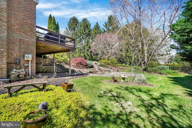 view of yard with stairway and a deck
