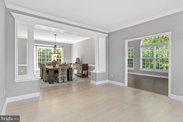 dining area with ornate columns, crown molding, wood finished floors, and baseboards