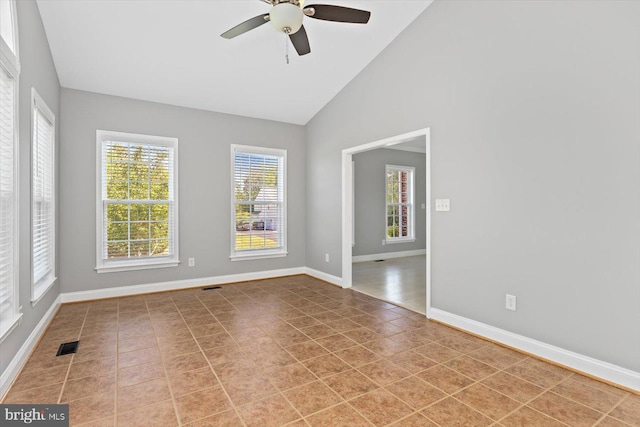 unfurnished room featuring a ceiling fan, baseboards, and high vaulted ceiling