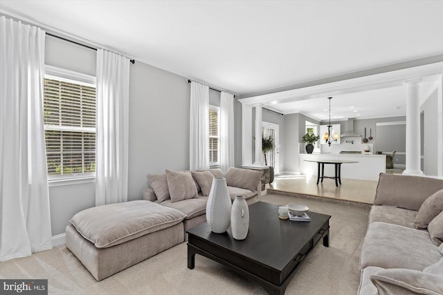 living area with light carpet, a chandelier, baseboards, and recessed lighting