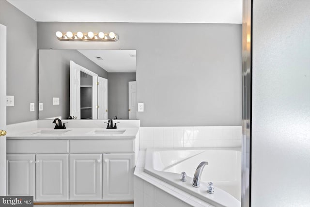 bathroom with a garden tub and double vanity