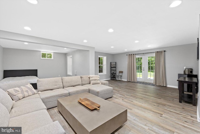 living area featuring recessed lighting, light wood-type flooring, baseboards, and french doors
