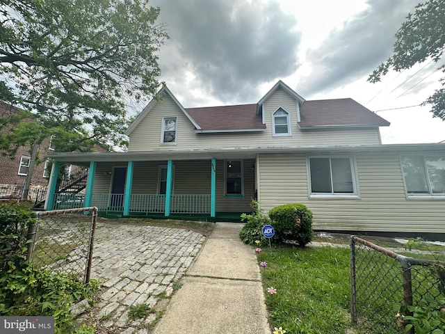 view of front of house featuring a porch and fence