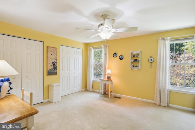 interior space with baseboards, ceiling fan, and a wealth of natural light