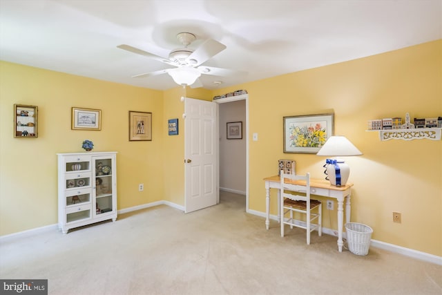 office space featuring carpet floors, ceiling fan, and baseboards