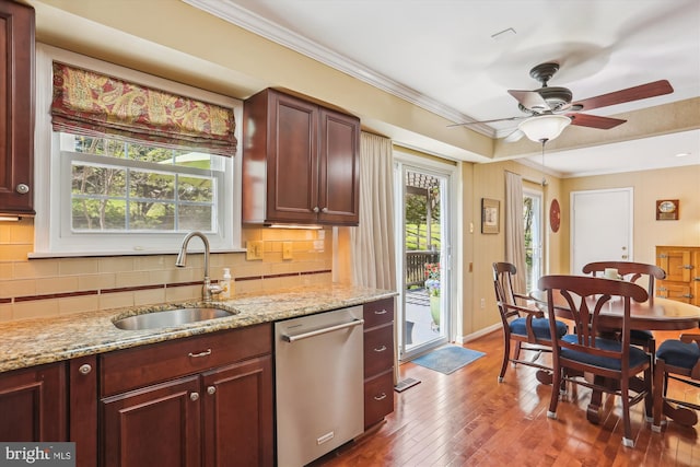 kitchen featuring stainless steel dishwasher, backsplash, a sink, and dark wood-type flooring