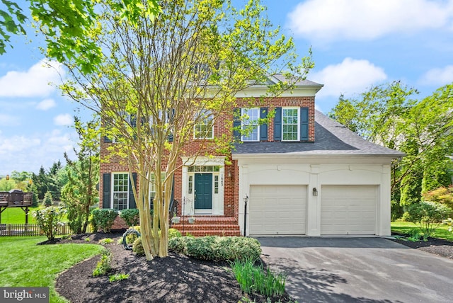 view of front of property with brick siding, a front lawn, fence, and driveway