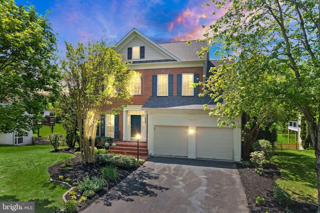view of front of house featuring a garage, a front lawn, fence, a standing seam roof, and driveway