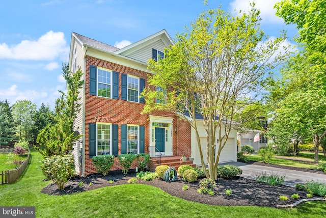 view of front of home with brick siding, a front lawn, and driveway