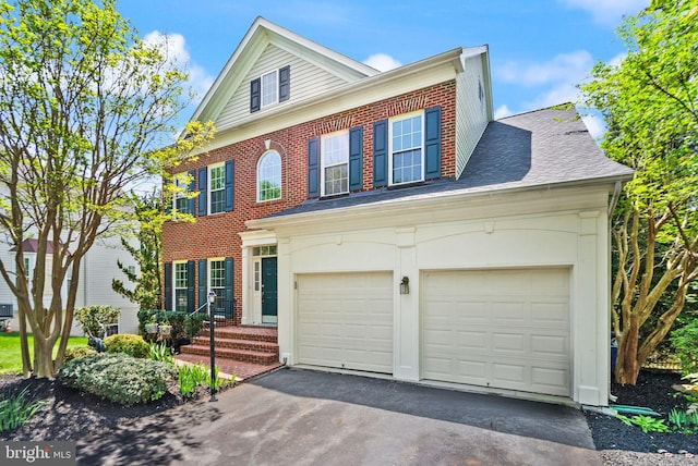 view of front of home featuring brick siding, a garage, a shingled roof, and aphalt driveway