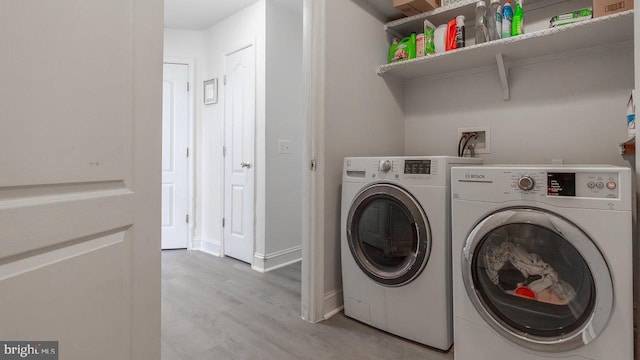 11400 Rolling Green Pl, Hagerstown, MD 21742 - washroom featuring laundry area, wood finished floors, baseboards, and washer and dryer