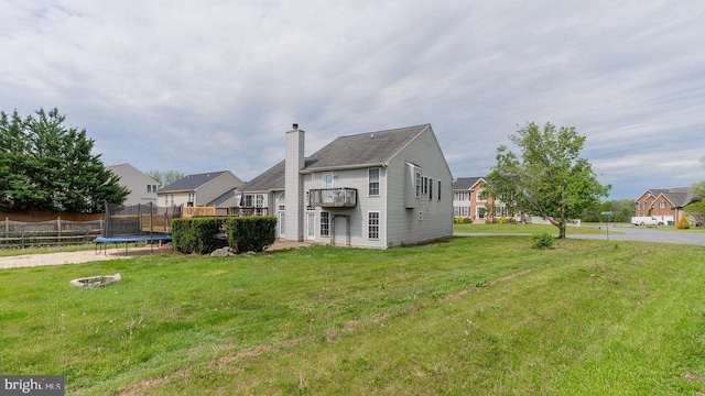 11400 Rolling Green Pl, Hagerstown, MD 21742 - rear view of property featuring a lawn, a chimney, a balcony, fence, and a trampoline