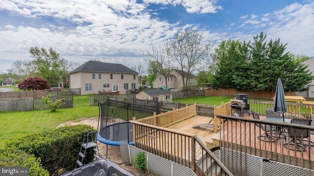 11400 Rolling Green Pl, Hagerstown, MD 21742 - deck featuring a trampoline, a yard, outdoor dining area, and a fenced backyard