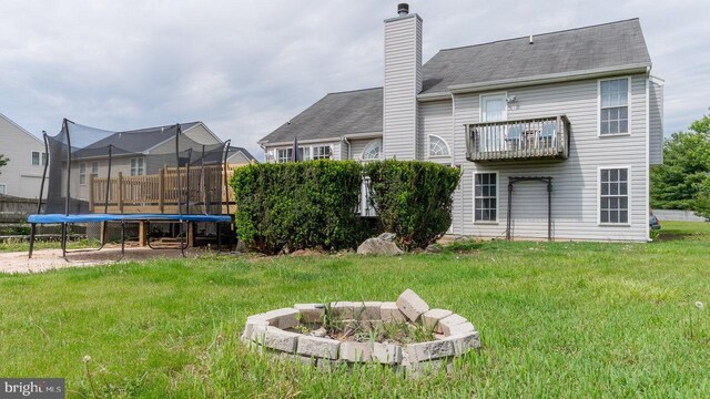 11400 Rolling Green Pl, Hagerstown, MD 21742 - rear view of property with a lawn, a trampoline, a chimney, and a balcony