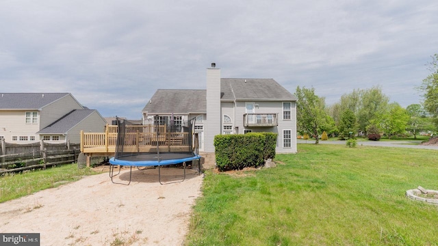 11400 Rolling Green Pl, Hagerstown, MD 21742 - back of house featuring a lawn, a chimney, fence, a trampoline, and a deck