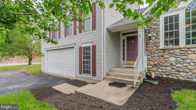 11400 Rolling Green Pl, Hagerstown, MD 21742 - property entrance featuring an attached garage, roof with shingles, and aphalt driveway