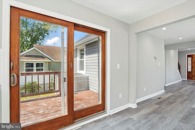 entryway featuring baseboards, recessed lighting, and wood finished floors