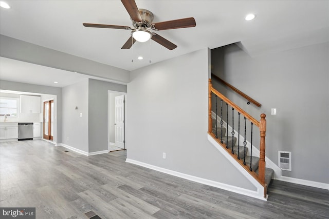 unfurnished living room with baseboards, a ceiling fan, recessed lighting, and wood finished floors