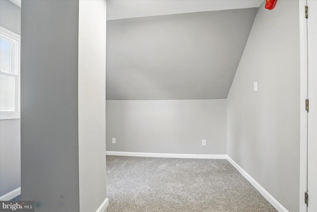 bonus room featuring carpet flooring, baseboards, and lofted ceiling