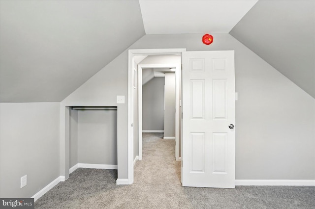 bonus room featuring carpet floors, baseboards, and lofted ceiling