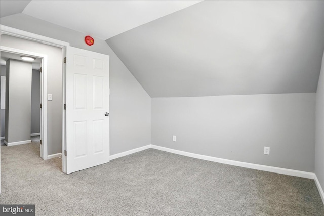 bonus room with baseboards, carpet, and vaulted ceiling