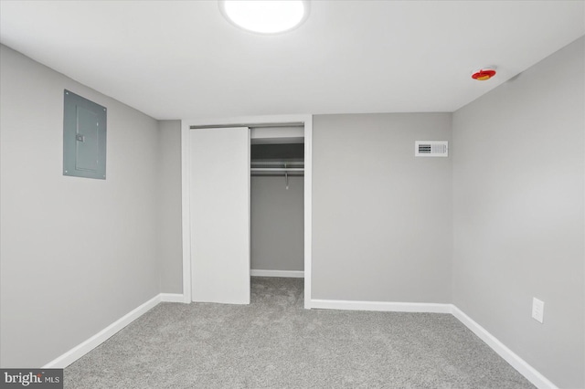 unfurnished bedroom with electric panel, visible vents, baseboards, a closet, and carpet