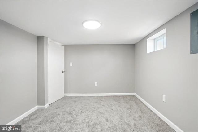 basement featuring carpet flooring and baseboards