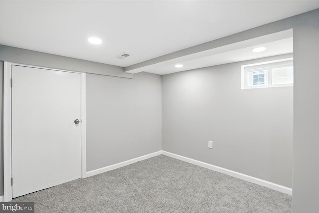 below grade area featuring baseboards, carpet, recessed lighting, and visible vents