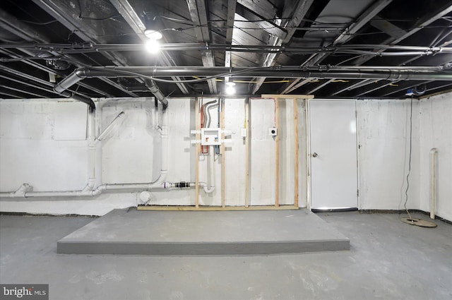 unfinished basement featuring electric panel