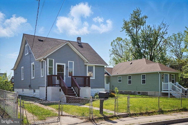 bungalow featuring a shingled roof, a fenced front yard, a gate, and a front yard