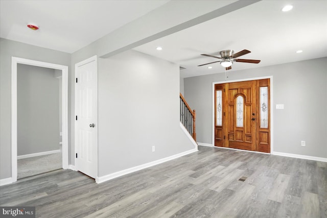 entryway featuring ceiling fan, wood finished floors, stairway, baseboards, and recessed lighting
