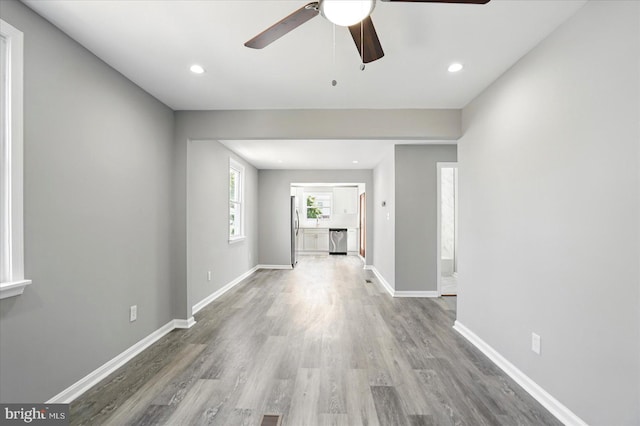 interior space with baseboards, ceiling fan, recessed lighting, and wood finished floors