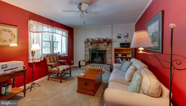 carpeted living room featuring crown molding, a ceiling fan, baseboards, and a brick fireplace
