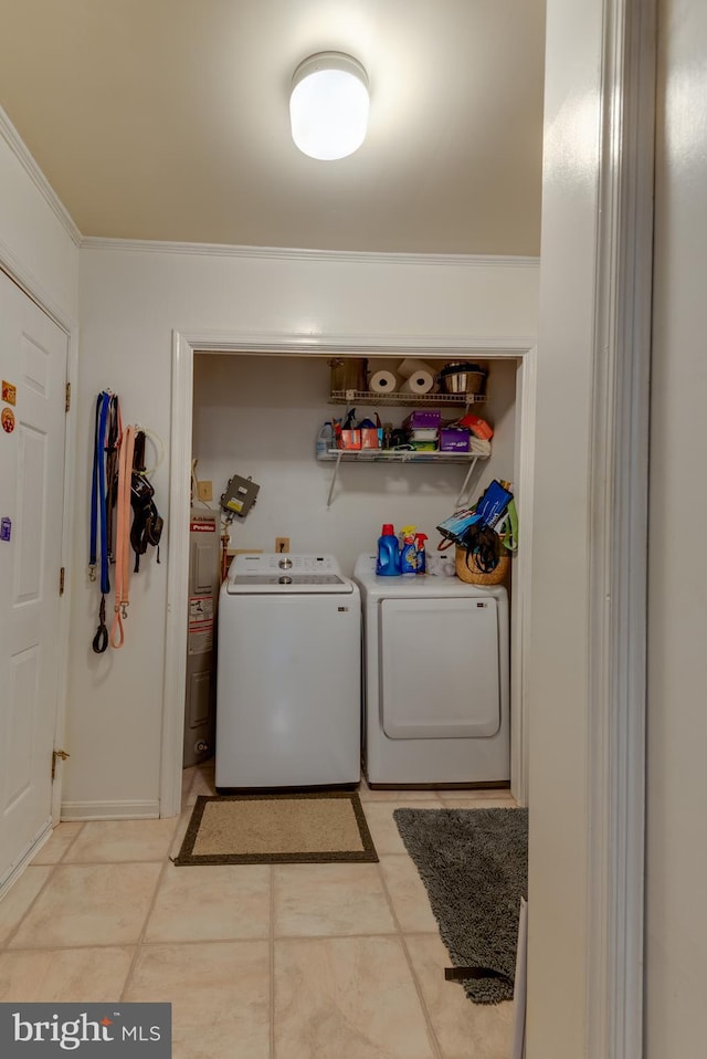 clothes washing area with washer and dryer, laundry area, crown molding, and water heater