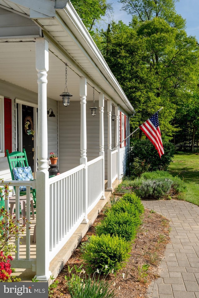 view of side of property with covered porch