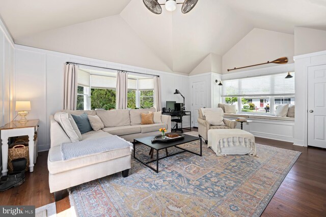 106 Boundary, Saint Michaels, MD 21663 - living room with dark wood-type flooring, a decorative wall, a wealth of natural light, and high vaulted ceiling