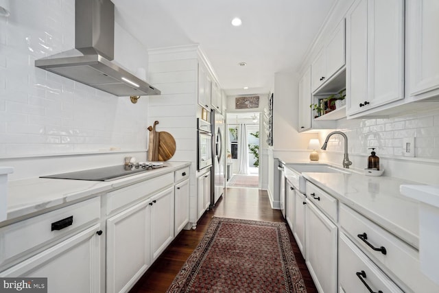 106 Boundary, Saint Michaels, MD 21663 - kitchen with wall chimney range hood, appliances with stainless steel finishes, a sink, and tasteful backsplash