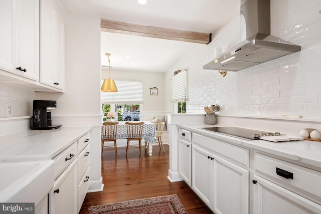 106 Boundary, Saint Michaels, MD 21663 - kitchen featuring beam ceiling, black electric cooktop, wall chimney exhaust hood, white cabinetry, and dark wood finished floors