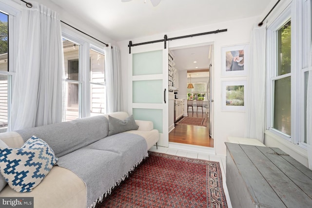 106 Boundary, Saint Michaels, MD 21663 - living room featuring tile patterned flooring and a barn door