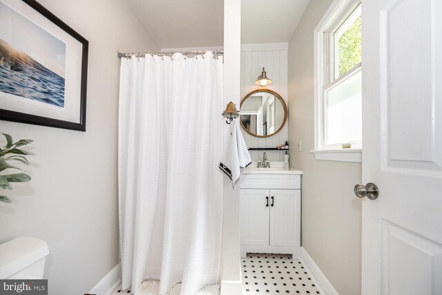 106 Boundary, Saint Michaels, MD 21663 - bathroom with vanity, toilet, tile patterned floors, baseboards, and curtained shower