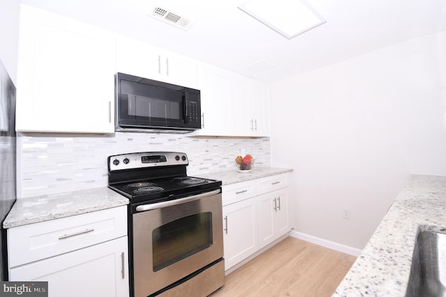 kitchen with white cabinets, black microwave, light wood finished floors, stainless steel electric stove, and visible vents