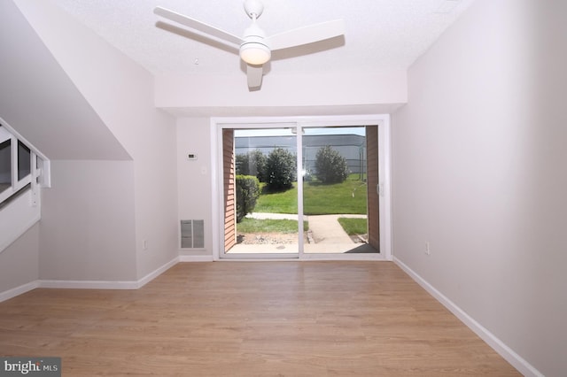 bonus room with visible vents, light wood-style flooring, ceiling fan, and baseboards