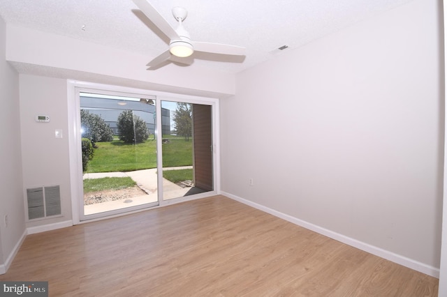 spare room with visible vents, light wood-style flooring, and baseboards